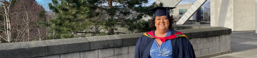 Kate Walker wearing her graduation cap and gown outside Liverpool Metropolitan Cathedral.